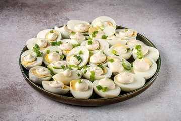 Boiled eggs with mayonnaise and green onions