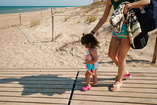 Mother and daughter walking along the promenade