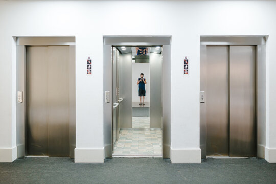 UGC Tourist taking selfie in hotel elevator with open doors