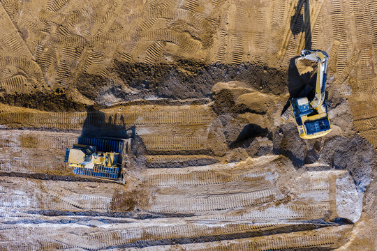 Aerial view of bulldozer and excavator working on construction site