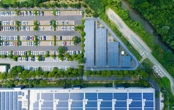 Aerial view of parking lot with cars and solar panels