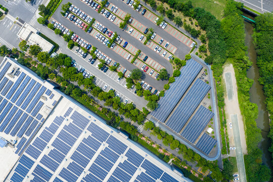 Aerial view of parking lot with cars and solar panels