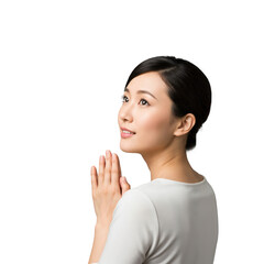 Beautiful young Asian woman with a serene expression and hands clasped in a gesture of prayer or hope, looking upwards against a dark background.