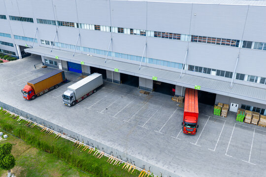 Logistics warehouse with trucks loading and unloading