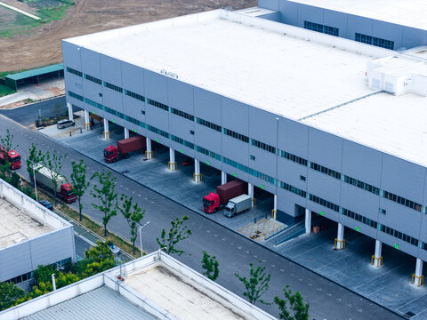 Aerial view of logistics and industrial buildings with trucks