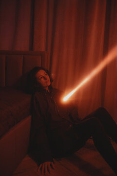 Dark portrait of a woman with a ray of light from the heart area