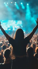 Silhouette of a woman with arms raised in excitement at a vibrant live music concert with bright stage lights and a cheering crowd