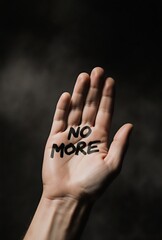 raised hand displaying 'no more' message as a protest symbol for social justice awareness | social justice, human rights, activism, feminism, equality theme