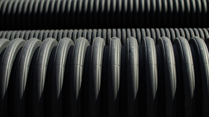 Stacked Black Corrugated Pipes