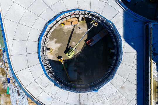 Aerial view of circular construction site with workers