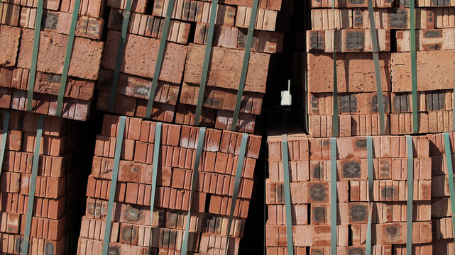 Stacks of Red Bricks with Straps