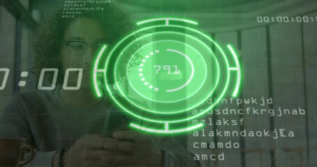 Woman wearing glasses holding smartphone, examining green circular HUD in office, code fragments