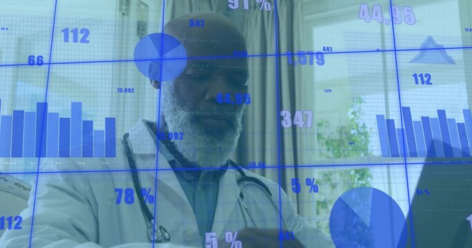 Reviewing data charts on laptop senior physician wearing lab coat and stethoscope in office