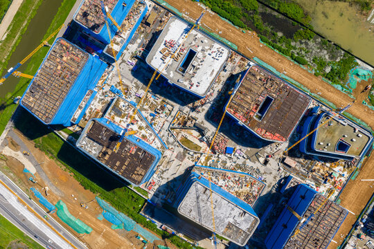Aerial view of construction site with concrete formwork and cranes