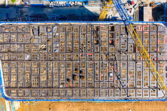 Aerial view of construction site with concrete formwork and cranes