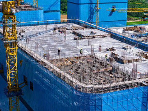 Aerial view of construction site with concrete formwork and cranes
