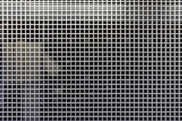 Grid structure on ceiling with industrial background showing geometric symmetry and design