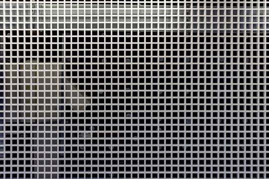 Grid structure on ceiling with industrial background showing geometric symmetry and design