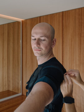 Personal Trainer Preparing Client for EMS Training 