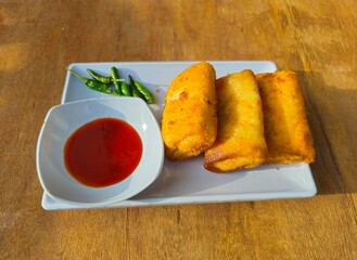 fish and chipsRisole,Rissoles,Risol is snack fiiled with vegetables,smoked beef,sausage,cheese,mayonnaise sauce,wrapped in risol skin and bread crumbs served with green cayenne pepper and chili sauce 
