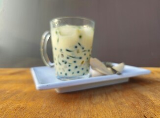 glass of milkCendol is an iced sweet dessert contains pandan flavored green rice flour jelly,coconut milk and pandan sugar,additional toppings are dinced jackfruit,red bean,durian.Javanese called Dawe
