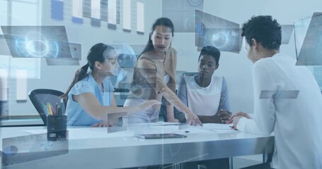 Female colleagues standing at table, pointing at plan and revealing floating UI charts for design - Powered by Adobe