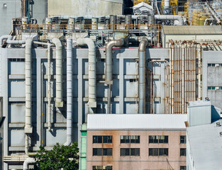 Industrial Plant With Vertical Pipes And Brick Buildings