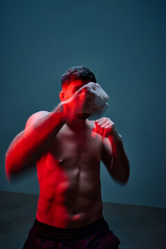 Boxer training in an intense lighting setup for technique improv