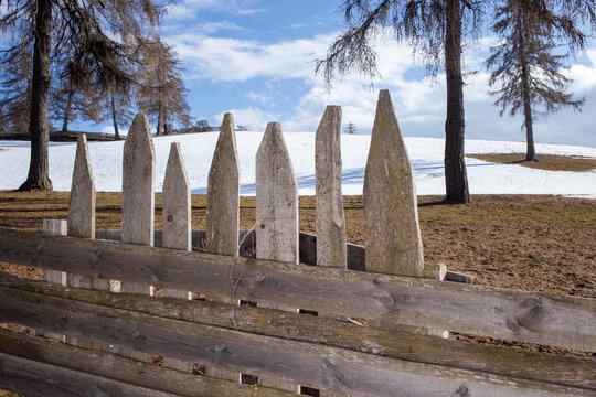 Wooden picket fence in winter in the mountains