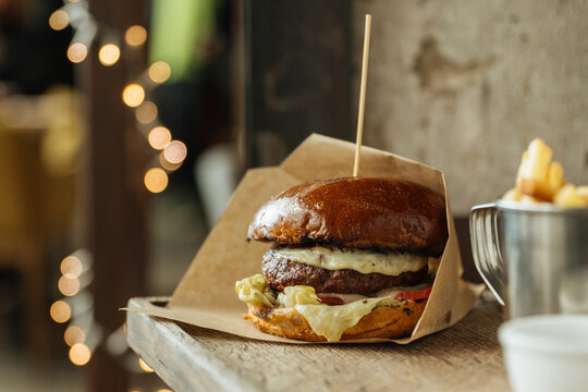 Cheeseburger with Lettuce and Tomato on Wooden Surface