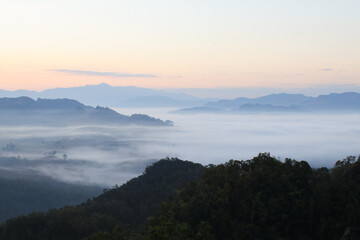 Beautiful morning mountains range and mist with the sunrise. Creating a peaceful and atmospheric. Before sunrise. 
