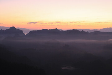 Obraz premium Beautiful morning mountains range and mist with the sunrise. Creating a peaceful and atmospheric. Before sunrise. 