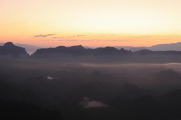 Beautiful morning mountains range and mist with the sunrise. Creating a peaceful and atmospheric. Before sunrise. 