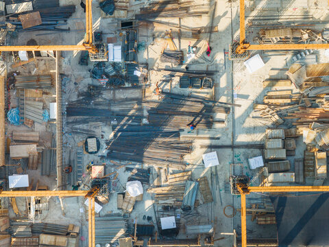 Aerial Construction Site with Cranes and Workers