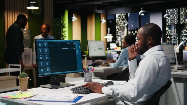 Young man PC user interacting with AI chat system on pc at office late at night, highlighting the evolution of artificial intelligence. Chatbot services and digital tools for productivity. Camera A.