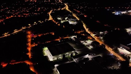 Stunning Aerial Night View of a Vibrant Cityscape Illuminated by Streetlights and Buildings