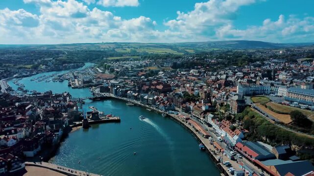 Historic port entrance with pleasure boats and beach