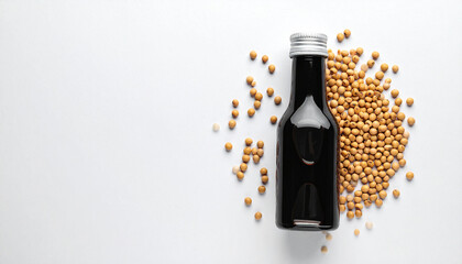 A soy sauce bottle glass container with soybeans around it, shot from above, flat lay