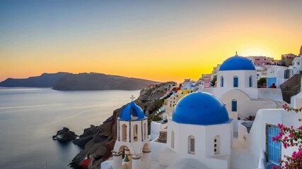 Golden sunset bathes picturesque cliffside village iconic white buildings brilliant blue domes and bell tower Pink flowers frame the tranquil sea and distant rugged mountains - Powered by Adobe
