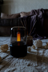 Home fragrance aromatic diffuser with essential oil. Modern air humidifier at home. Improving the comfort of wellbeing living in house. Ultrasonic aroma perfume steam technology