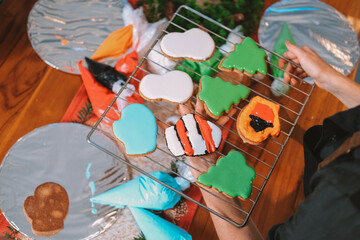 An overhead view of a board displaying Christmas gingerbread cookies baked by children during a holiday workshop. Children baking party. Preparing for New Year and Christmas.