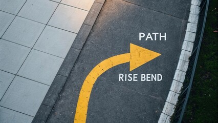 Yellow Arrow Direction Sign on Gray Sidewalk Indicating Path Rise Bend in Urban Environment for Navigation and Guidance