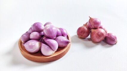 Red onion on wooden plate. Isolated on white background with copy space. Perfect for design element, ingredients food spices or any commercial usage.