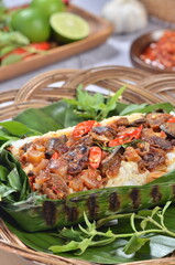 Grilled rice with fried potatoes and liver, wrapped in banana leaves, a traditional Indonesian dish