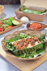 Grilled rice with fried potatoes and liver, wrapped in banana leaves, a traditional Indonesian dish