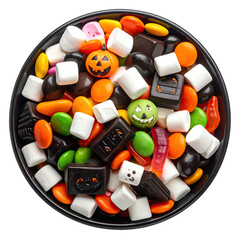 Overhead shot of a black bowl overflowing with assorted candies and Halloween-themed sweets