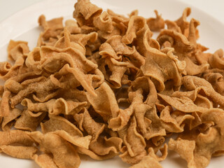 Keripik Usus or fried chicken intestine, piled on white background