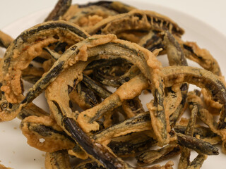Keripik belut is made from fried eel with batter until crispy, on white background