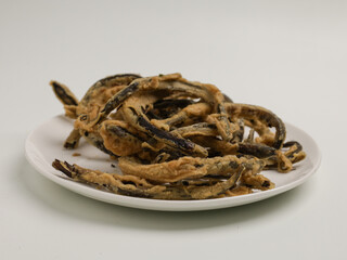 Keripik belut is made from fried eel with batter until crispy, on white background