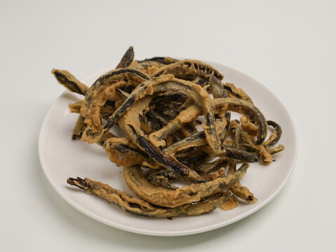Keripik belut is made from fried eel with batter until crispy, on white background
